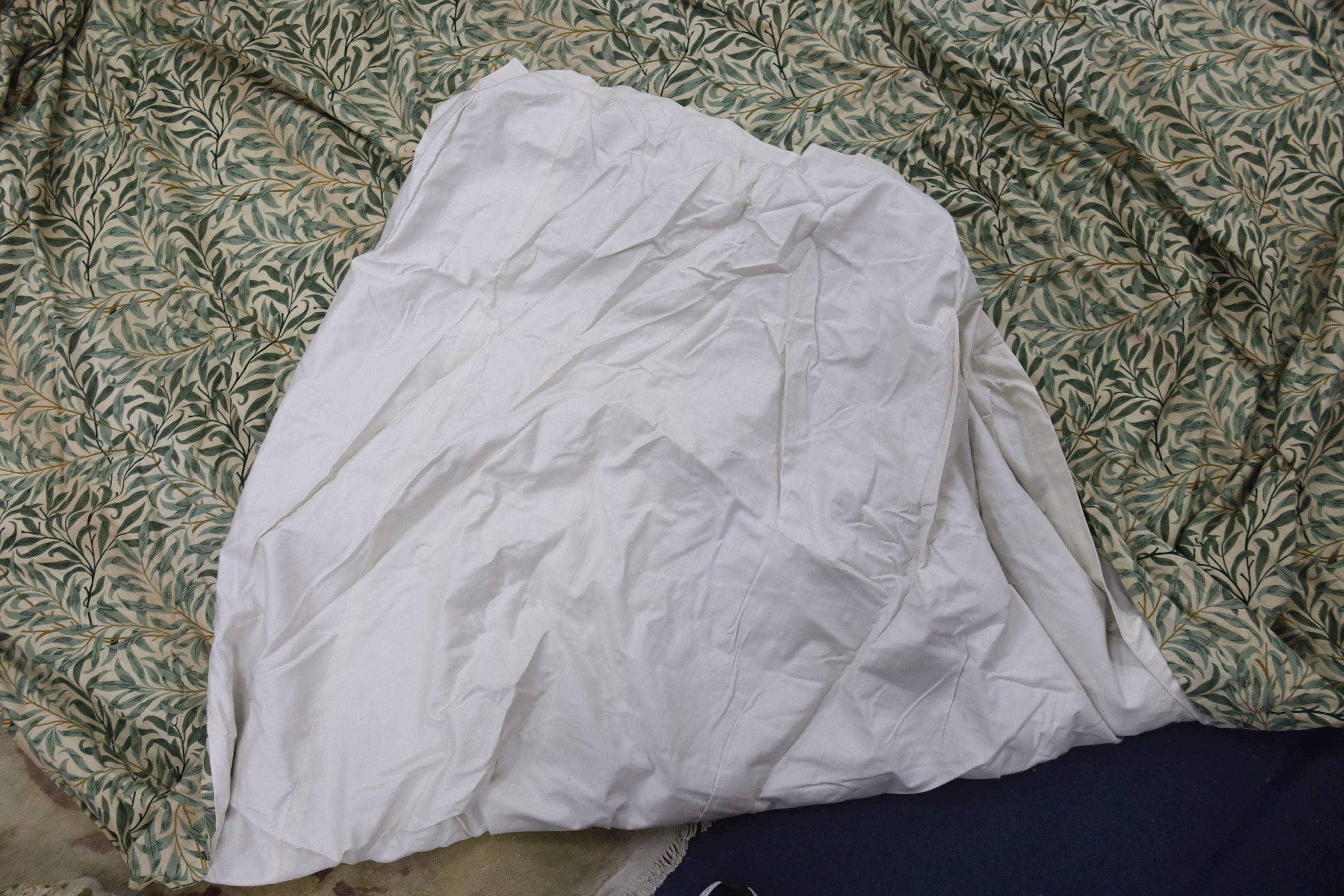 A pair of linen, 'Morris' style curtains and another pair of cotton curtains with a pineapple design